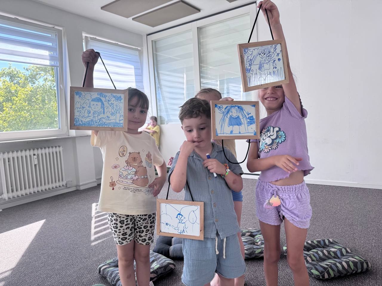 Kinder zeigen ihre Bilder